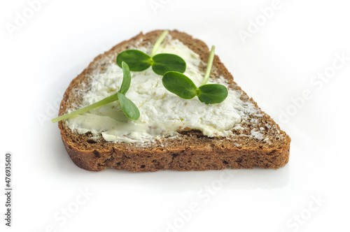 Sandwich on rye toast with sunflower micro green and cream cheese on white background. Healthy vegetarian food. Tasty breakfast. Micro greens as a health benefit.