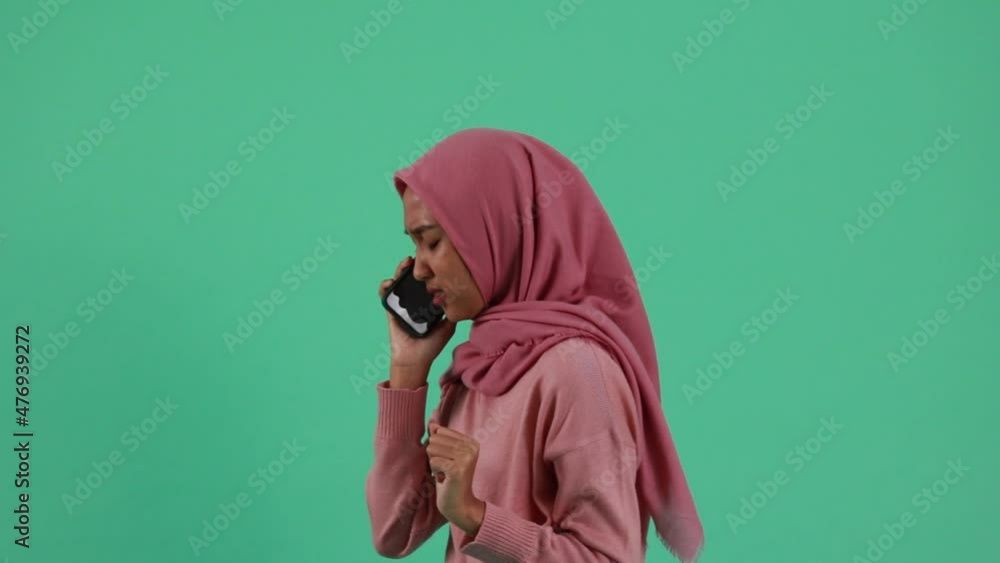 portrait of Asian Woman using smartphone on green background. portrait of Asian Woman using smartphone on green background.