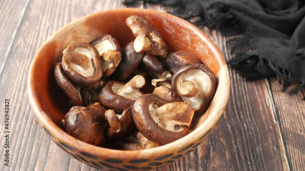 raw champignon mushroom in a bowl on table raw champignon mushroom in a bowl on table