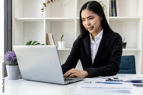Businesswoman viewing financial data on laptop, she is reviewing financial data to bring to meetings with business partners. Concept of company financial management. Checking financial information.