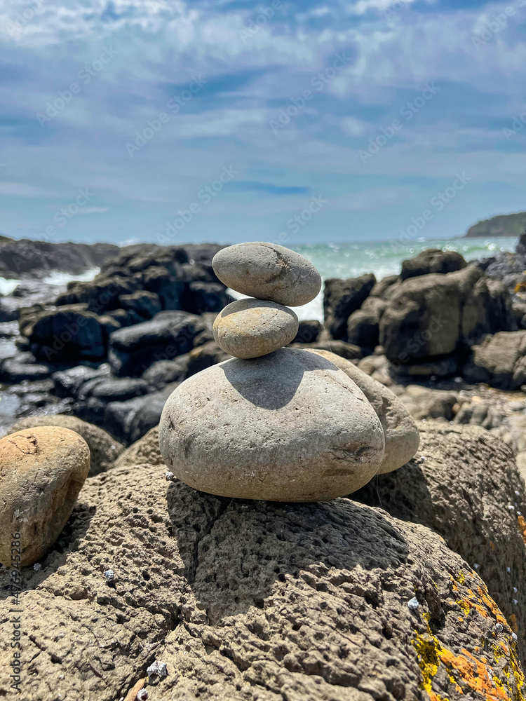 Calming stacked rocks on a beach at Cathedral Rocks, Kiama, New South Wales, Australia Calming stacked rocks on a beach at Cathedral Rocks, Kiama, New South Wales, Australia