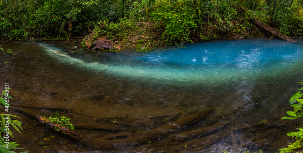 Two clear rivers with different acidity mix and create the river with turquoise water. Rio Celeste, Costa Rica