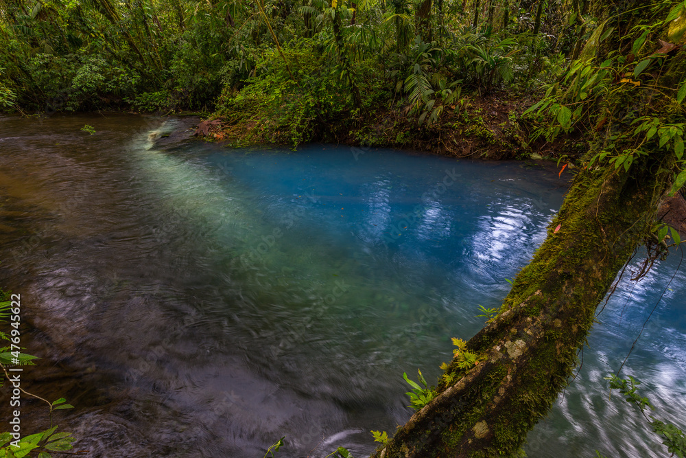 Two clear rivers with different acidity mix and create the river with turquoise water. Rio Celeste, Costa Rica Two clear rivers with different acidity mix and create the river with turquoise water. Rio Celeste, Costa Rica