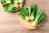 Fresh Bok Choy or Pak Choi (Chinese cabbage) on cutting wooden board, Top view
