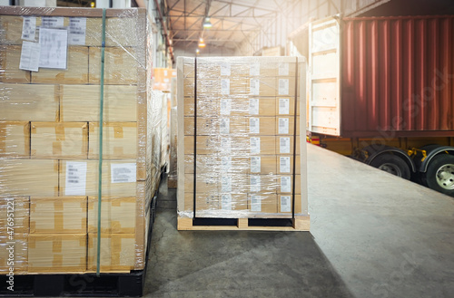 Package Boxes Wrapped Plastic Film on Pallets Loading with Shipping Cargo Container. Supply Chain. Trucks Parked Loading at Dock Warehouse. Shipment Logistics. Cargo Freight Truck Transport.