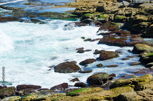 Ocean Waves with white foam at rocky beach  Bondi bay  Sydney  Australia.