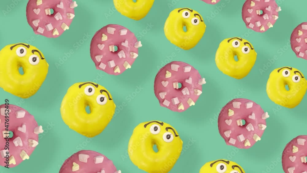 Colorful pattern of donuts isolated on green background with shadows. Seamless pattern with donut. Doughnuts. Top view. Realistic animation. 4K video motion Colorful pattern of donuts isolated on green background with shadows. Seamless pattern with donut. Doughnuts. Top view. Realistic animation. 4K video motion