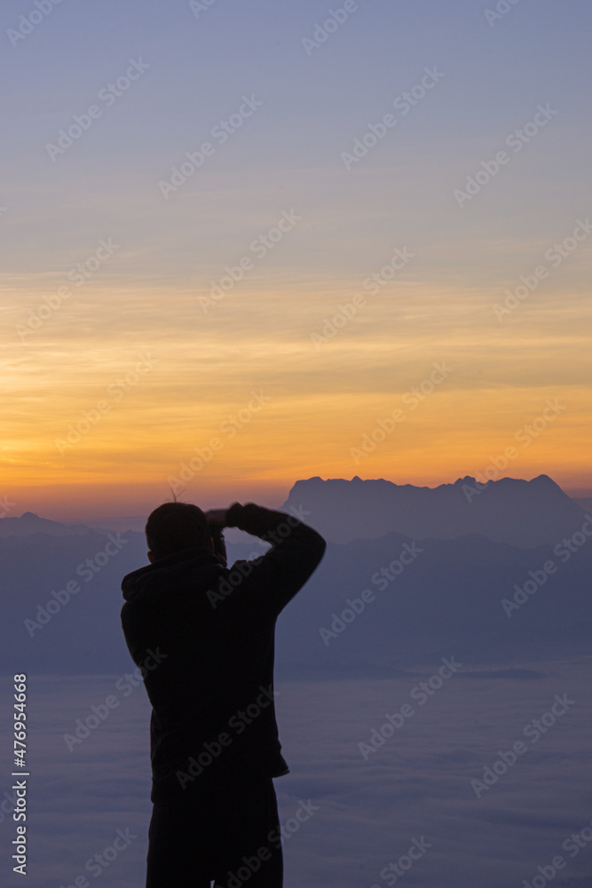 silhouette of a person watching the sunset