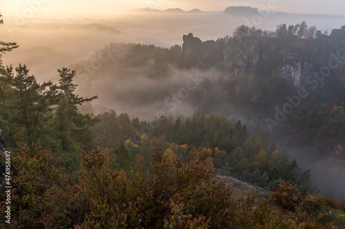 Sunrise in autumn foggy valley near Bastei