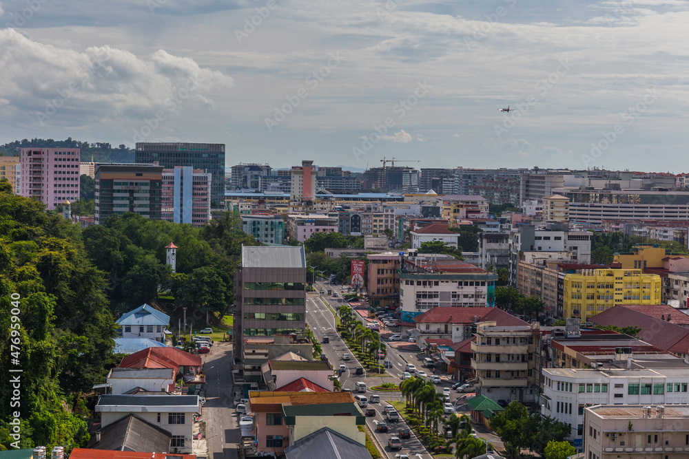 A plane landing over the downtown of city of Kota Kinabalu, Borneo