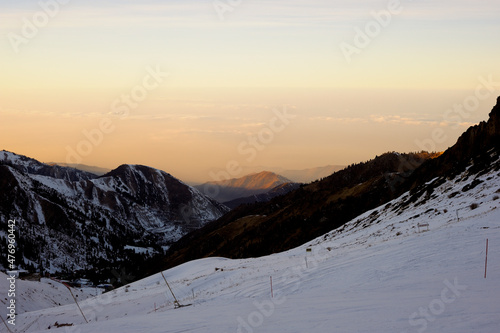 Active lifestyle and sports: rest in a ski resort. Skiing, snowboarding. Nice alpine view. Bright sunset
