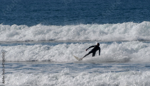 Surfer runs a big Wave at Pacific Beach In California, near Crystal Pier, during December holidays