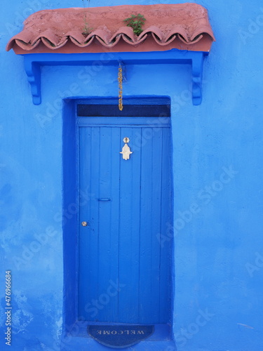 Islamic eave over door in african Chefchaouen town, Morocco - vertical © Jakub Korczyk