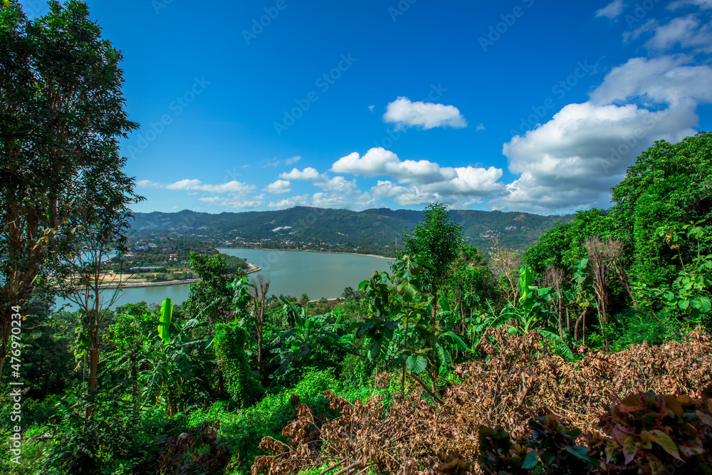Natural background with a walkway to see the scenery all around, overlooking the sea, trees, clear sky, the beauty of the ecosystem during travelling, the wind blows in a cool blur.