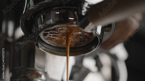 pull espresso shot with bottomless portafilter on a professional coffee machine