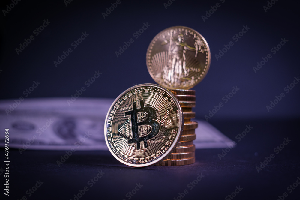 bitcoin coin leans on a stack of other gold coins bitcoin coin leans on a stack of other gold coins