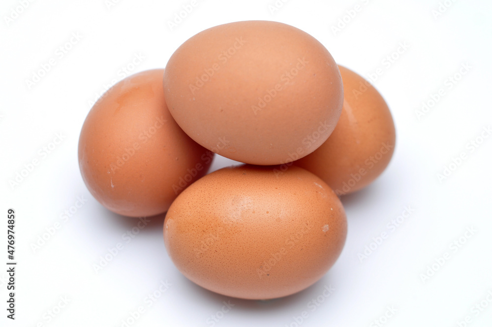 Photo of four eggs stacked on a white background Photo of four eggs stacked on a white background