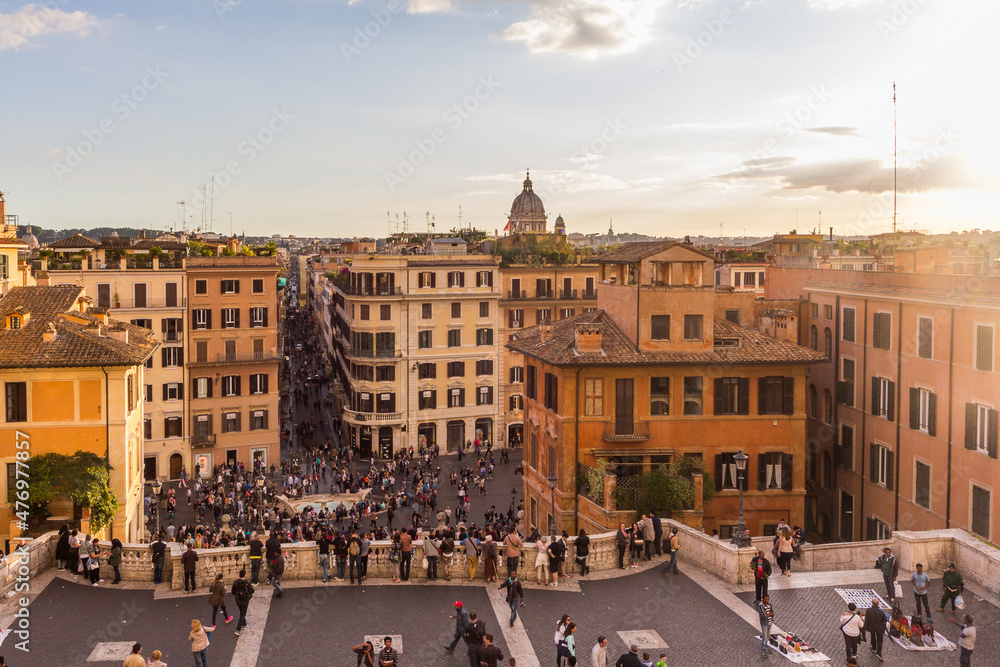 The Spanish Steps and Piazza di Spagna (Spain Square) with famous Fontana della Barcaccia (Fountain of the Ugly Boat) at sunset in Rome, Italy