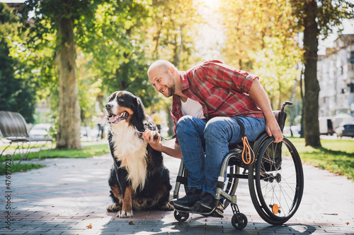 Happy young man with a physical disability who uses wheelchair with his dog Fotobehang