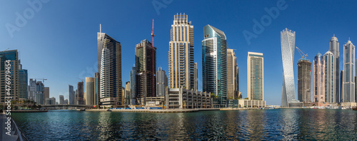 Modern skyscrapers and water pier of Dubai Marina, United Arab Emirates