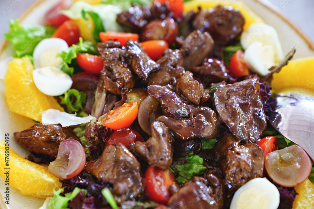 pieces of roasted meat on fresh vegetables with quail eggs. pieces of roasted meat on fresh vegetables with quail eggs.