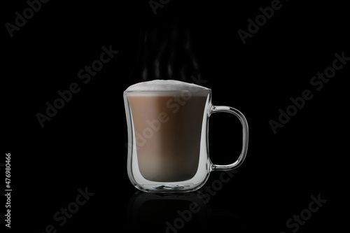 Coffee cup cappuccino on black background. Double glass cappuccino cup on the mirror. Glass cup of coffee on glass. Double glass cup isolated.