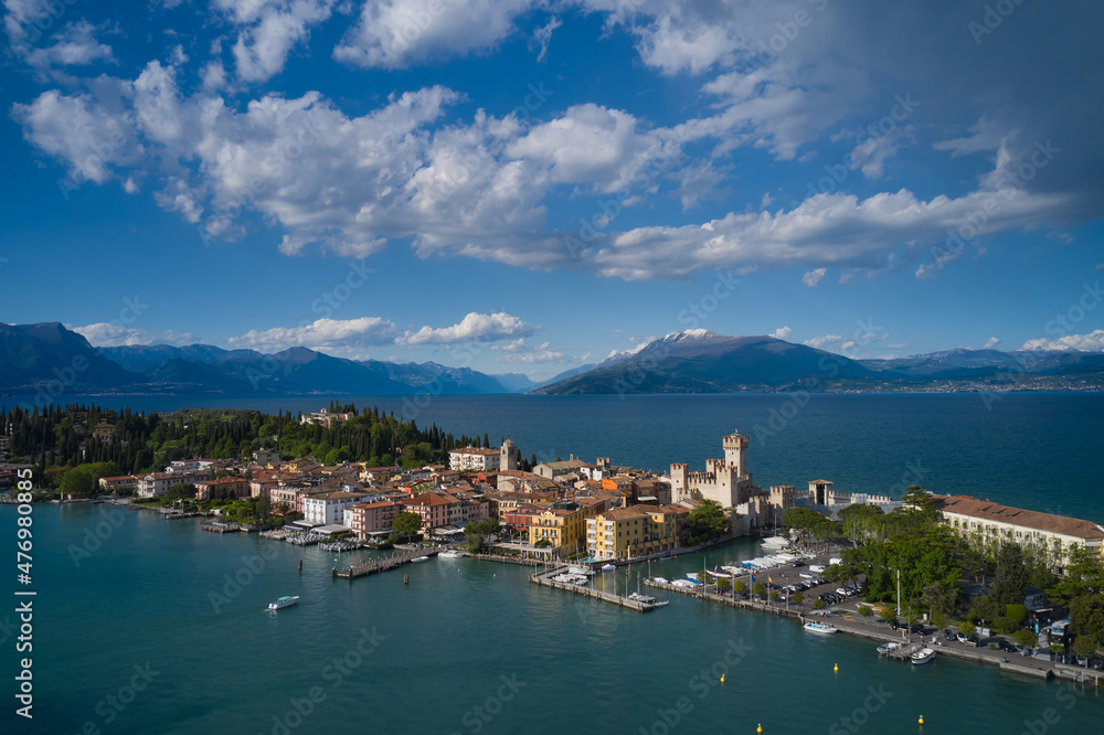 Sirmione, Lake Garda, Italy. Aerial view of the island of Sirmione. Castle on the water in Italy. Panorama of Lake Garda. Peninsula on a mountain lake in the background of the alps.