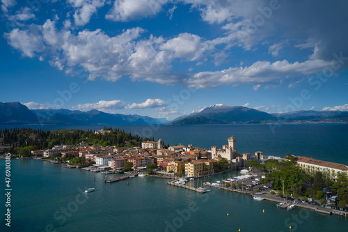 Sirmione, Lake Garda, Italy. Aerial view of the island of Sirmione. Castle on the water in Italy. Panorama of Lake Garda. Peninsula on a mountain lake in the background of the alps.