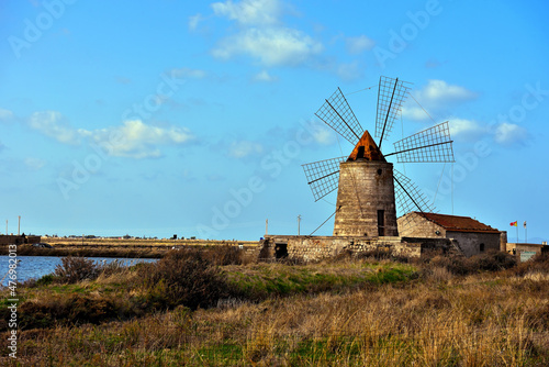 The salt flats with a windmill of Trapani, Sicily (Italy)