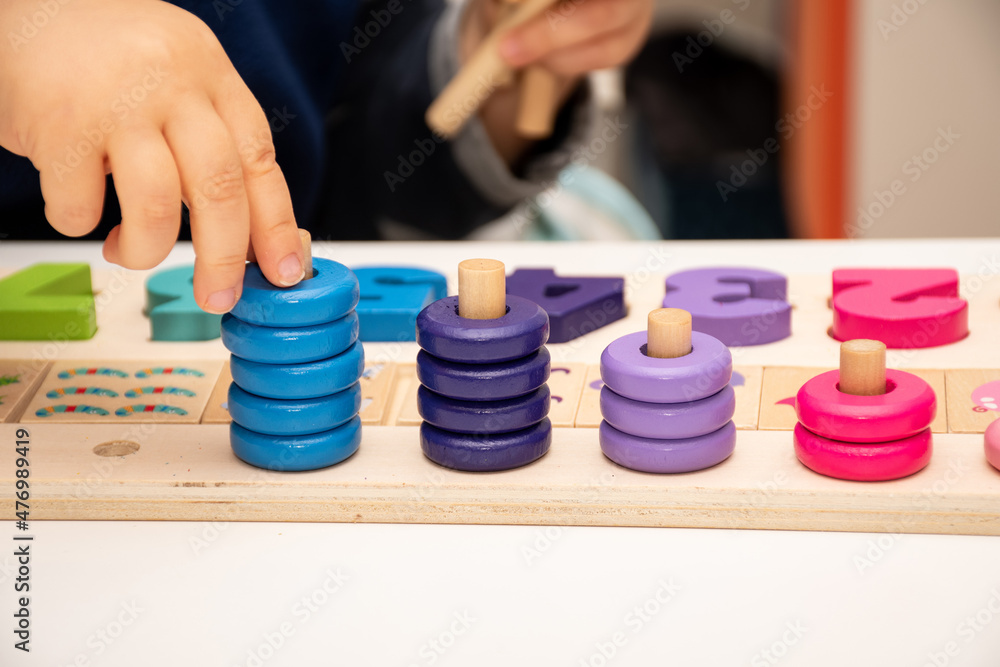 Baby toddler early development. Wooden stack and count rainbow colors learning game. Child learn colors and numbers Baby toddler early development. Wooden stack and count rainbow colors learning game. Child learn colors and numbers