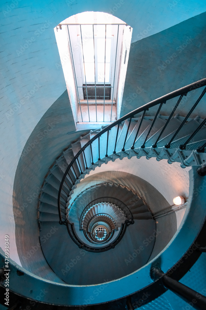 Fototapeta premium Looking down circular staircase inside historic lighthouse