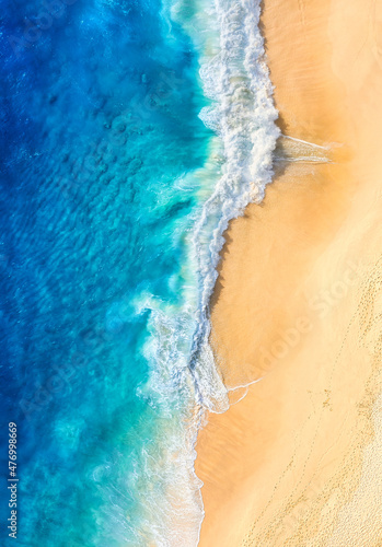 Beach and waves as a background from top view. Blue water background from drone.