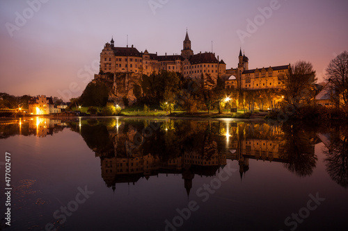 Sigmaringen Castle is reflected in the Danube at sunrise