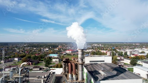 Smoke tower of industrial factory. Chimney smokestack emission.Refinery plant with pipes. Plant with smoke frow pipe and environmental pollution. Ecology concept and poor environment.
 photo