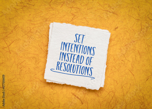 set intentions instead of resolutions inspirational advice or reminder - handwriting on a handmade paper, goal setting and personal development concept