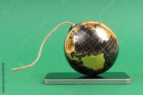 Global futuristic innovation concept. There is a planet on the smartphone in the form of an explosive bomb with a wick