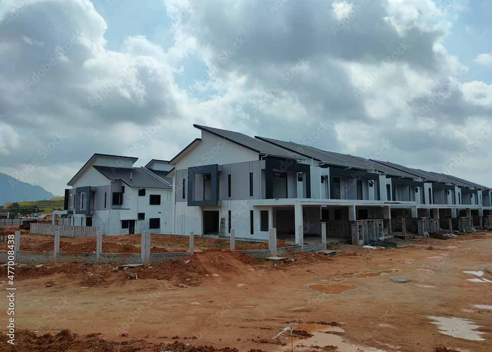 SEREMBAN, MALAYSIA -APRIL 16, 2020: Selected focused on new double story terrace house under construction in Malaysia. Designed by an architect with a modern and contemporary style. SEREMBAN, MALAYSIA -APRIL 16, 2020: Selected focused on new double story terrace house under construction in Malaysia. Designed by an architect with a modern and contemporary style.