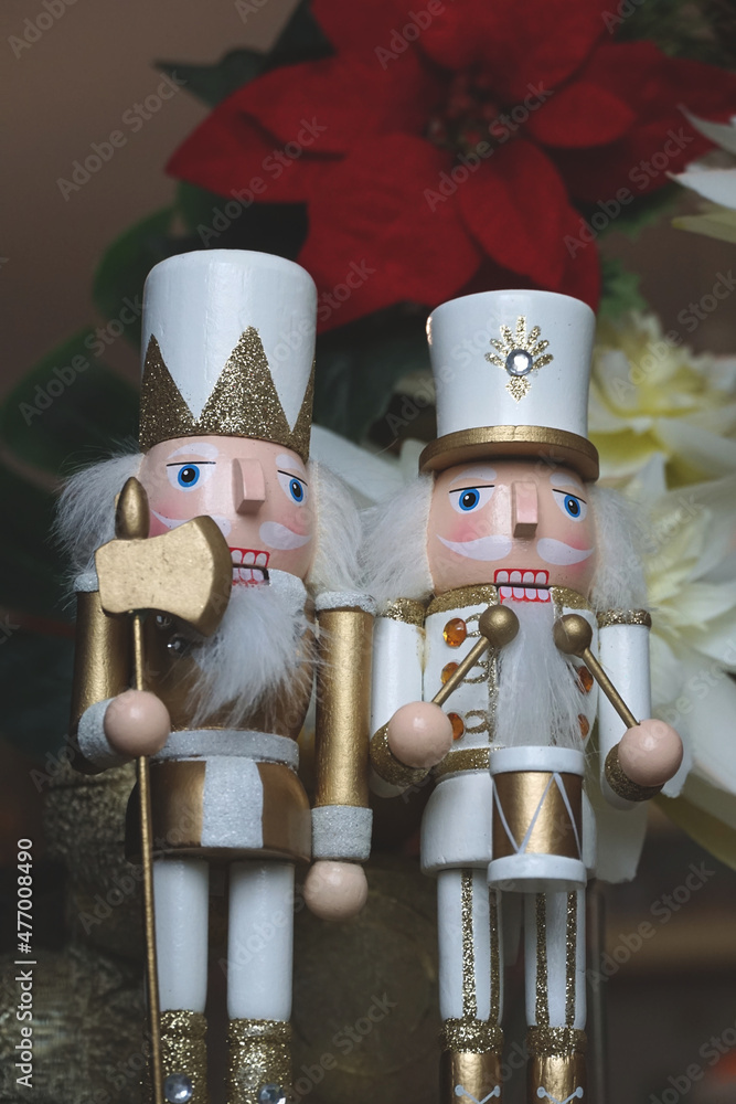 Figurines of two nutcrackers in white uniforms, symbols of Christmas