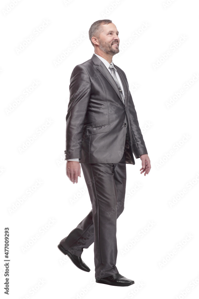 in full growth. confident business man striding forward. in full growth. confident business man striding forward.