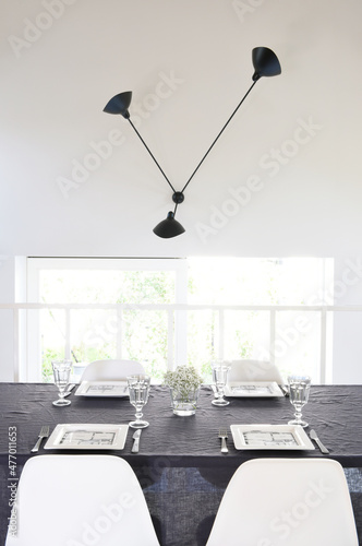 Contemporary black and white dining room with a dressed table