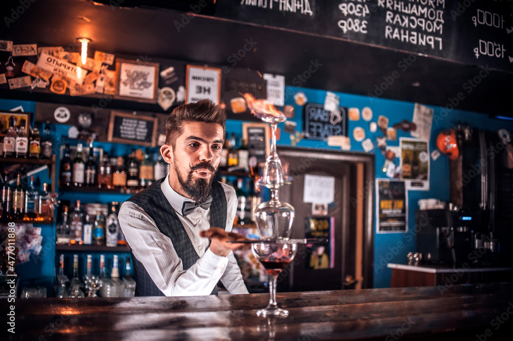 Focused Female bartender surprises with its skill bar visitors at the night club