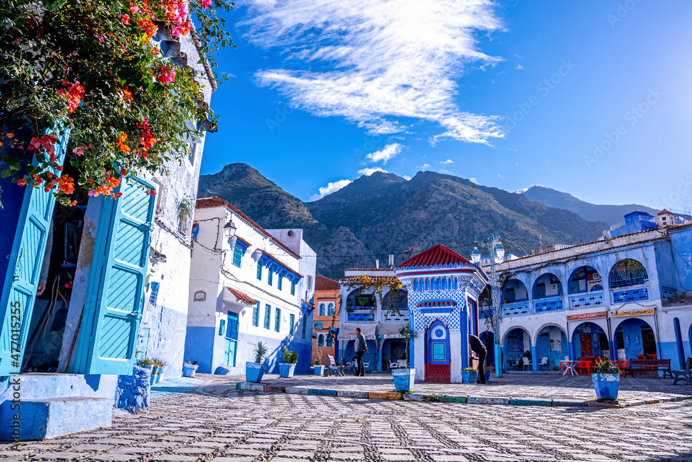 Public drinking water outlet between restaurant and traditional house at Chefchaouen, the blue city in the Morocco - obrazy, fototapety, plakaty 