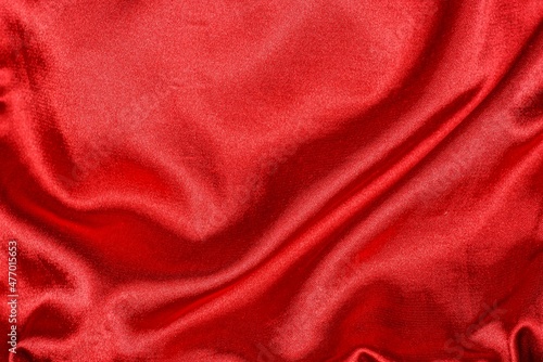 bright red background of crumpled piece of silk fabric