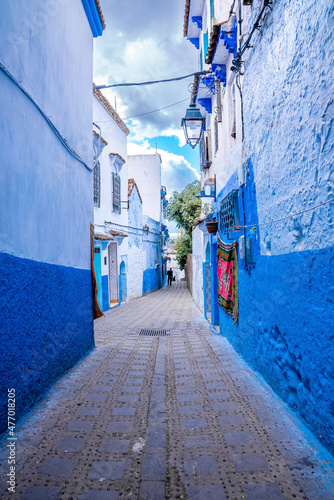 Blue colored residential alley leading to houses on both side, the blue city in the Morocco © ingusk