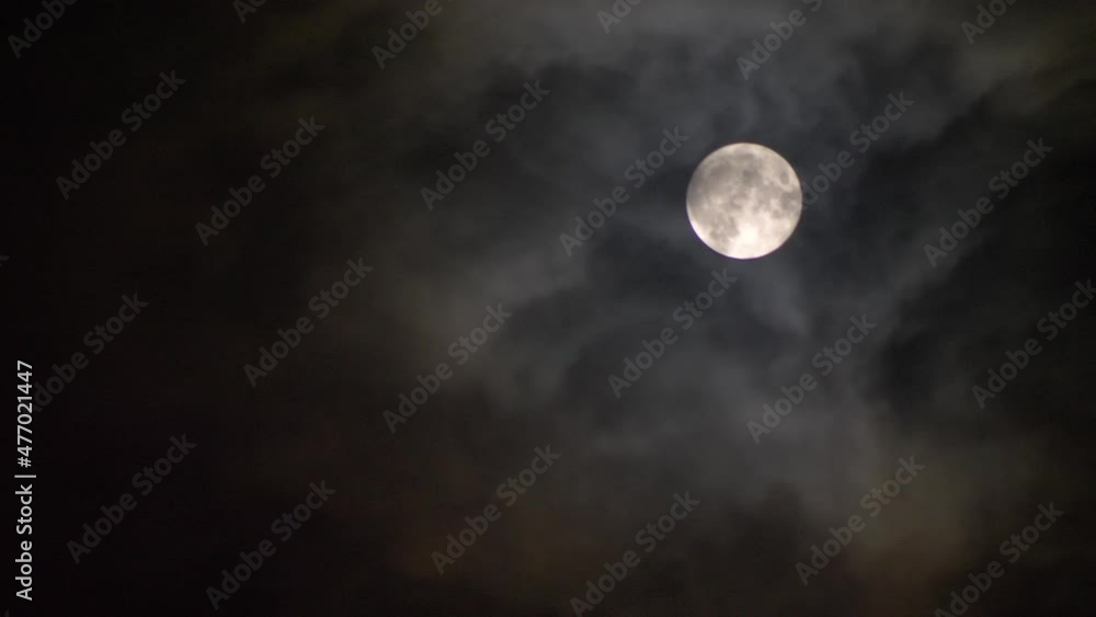 Clouds cover the full moon in the darkness. Video 4K Clouds cover the full moon in the darkness. Video 4K