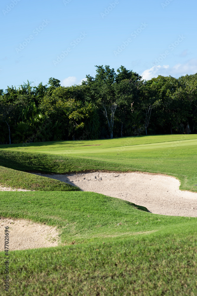 Vertical panoramic photo of a golf course in Mexico with sand bunkers Vertical panoramic photo of a golf course in Mexico with sand bunkers
