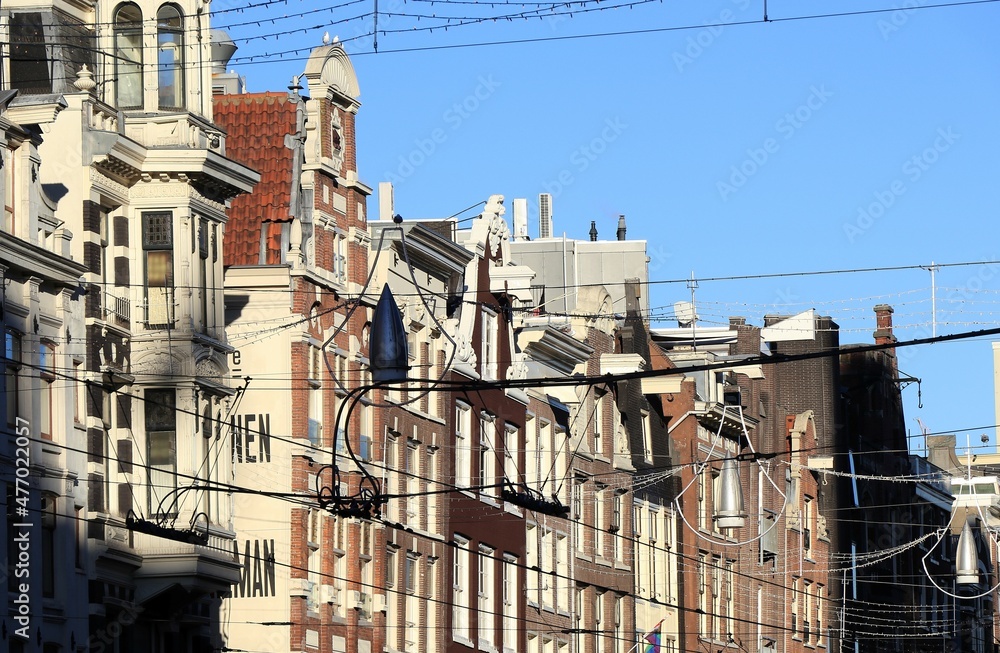 Amsterdam Damrak Street Traditional Building Facades with Blue Sky, Netherlands