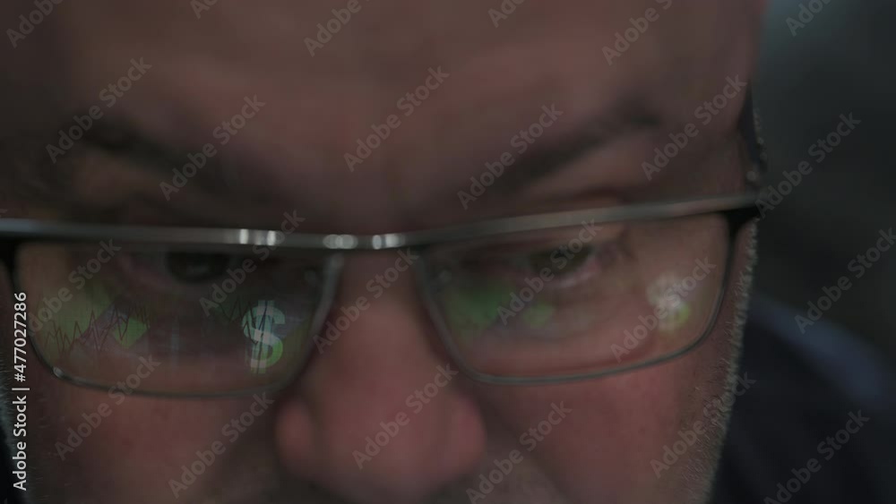 A businessman is analyzing a financial project. Success strategy. A man in glasses looks at the monitor screen A businessman is analyzing a financial project. Success strategy. A man in glasses looks at the monitor screen