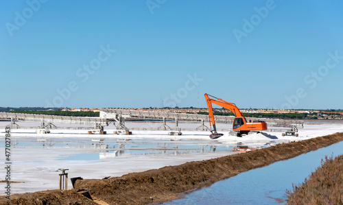 Excavator working in the production of salt