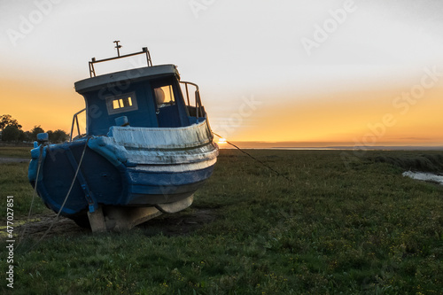 Old fishing boat at sunset in the Gower photo